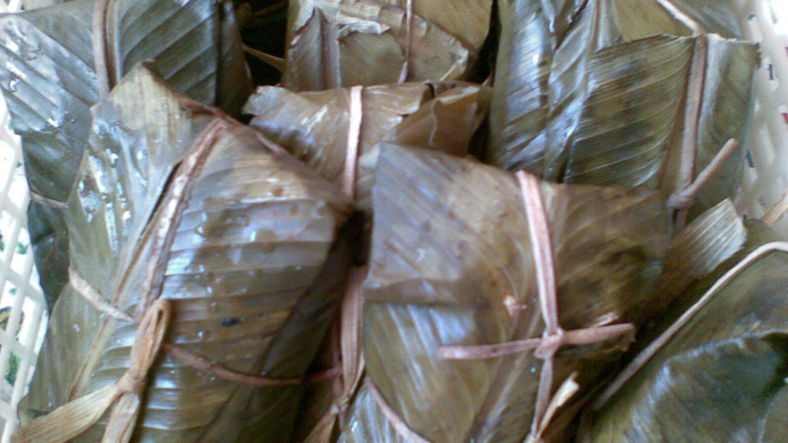 Nacatamales nicaragüenses envueltos en hoja de plátano y atados con cuerda